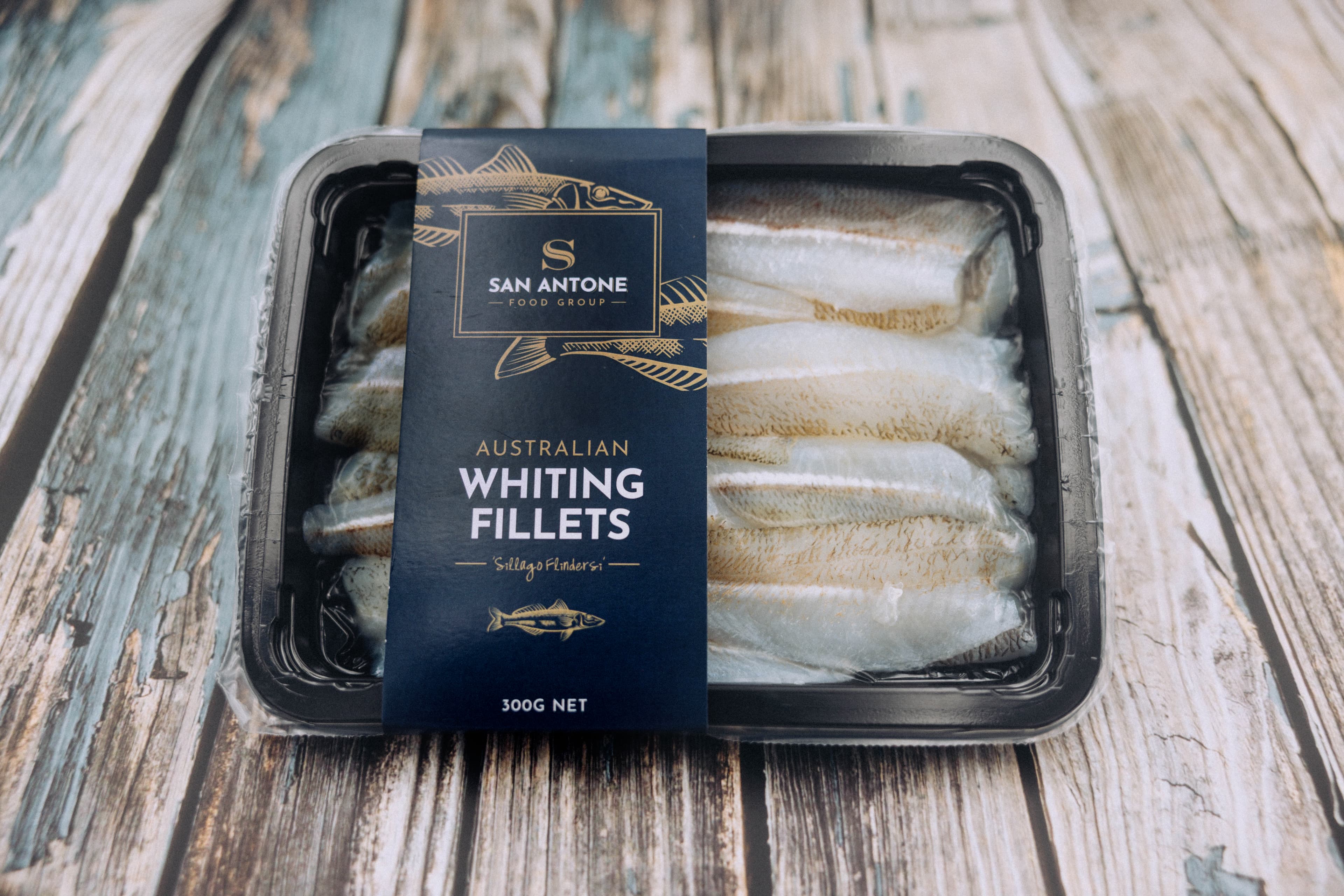 Plain Eastern School Whiting fillets on chopping board over ice