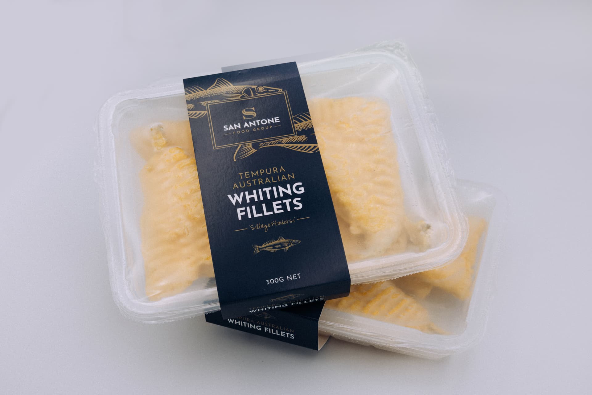 San Antone Signature Tempura Butterflied Whiting Fillets in clear retail trays, double stacked on white background